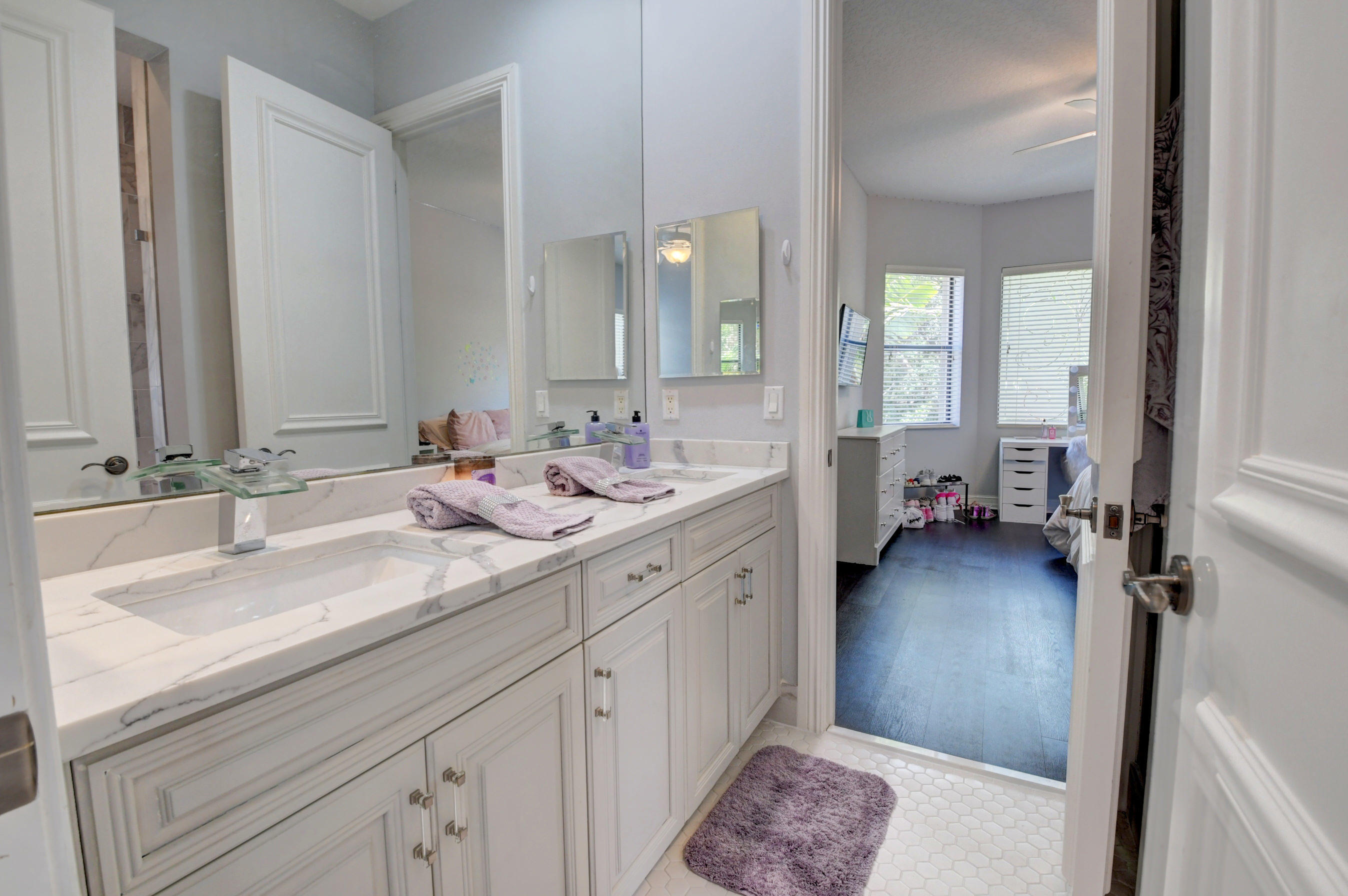 17798 Cadena Drive Boca Raton, FL 33496 - Photo 32 of 49 a en suite bathroom with a double vanity sink and a mirror
