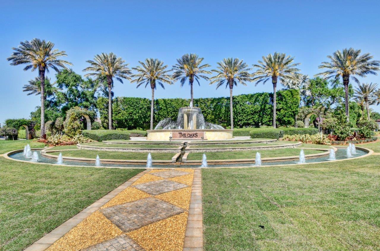 17798 Cadena Drive Boca Raton, FL 33496 - Photo 41 of 49 a view of a swimming pool with a bench and palm trees