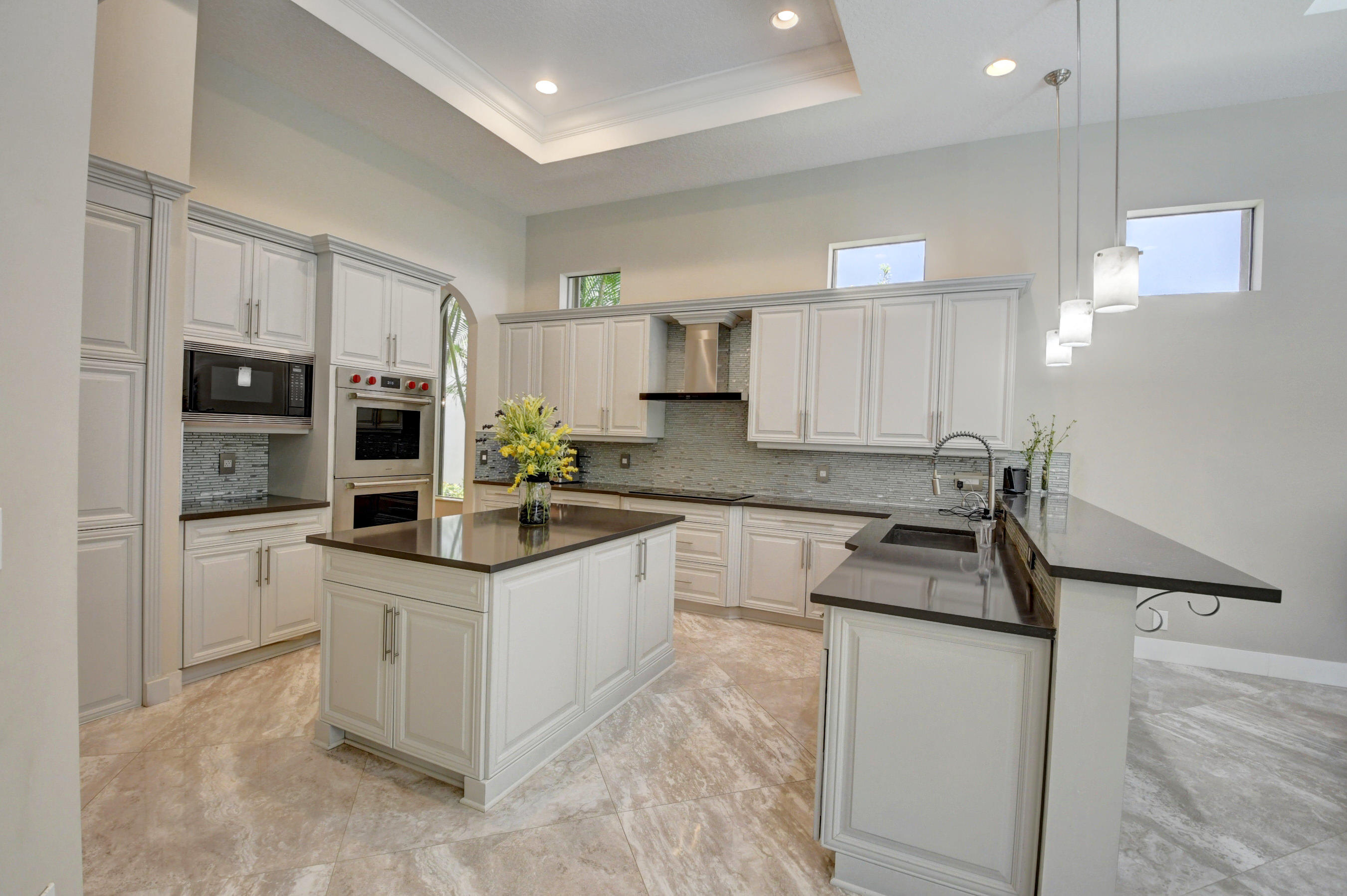 17798 Cadena Drive Boca Raton, FL 33496 - Photo 8 of 49 a kitchen with granite countertop a sink a counter top space appliances and cabinets