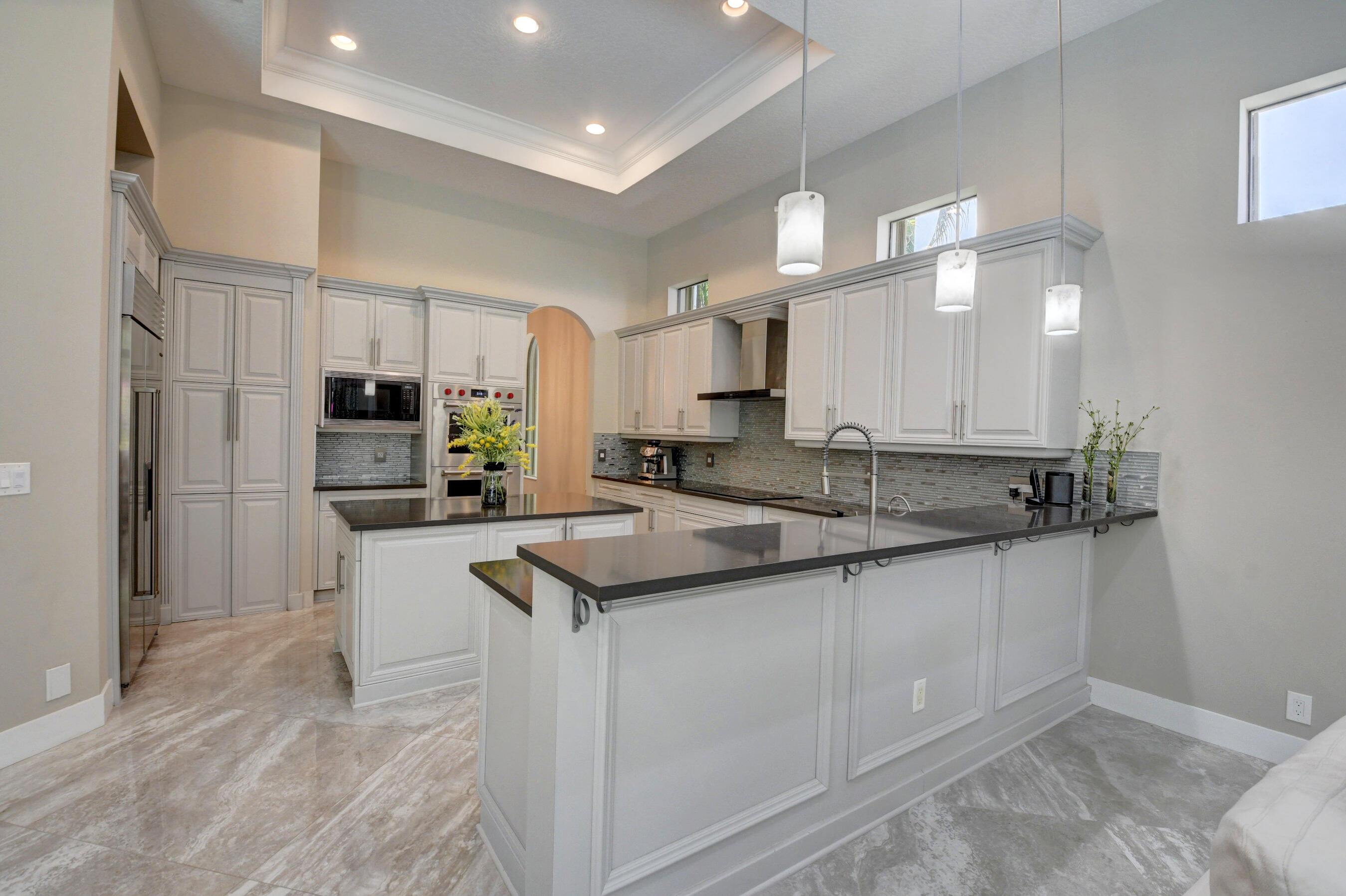 17798 Cadena Drive Boca Raton, FL 33496 - Photo 9 of 49 a kitchen with stainless steel appliances granite countertop a sink refrigerator and cabinets