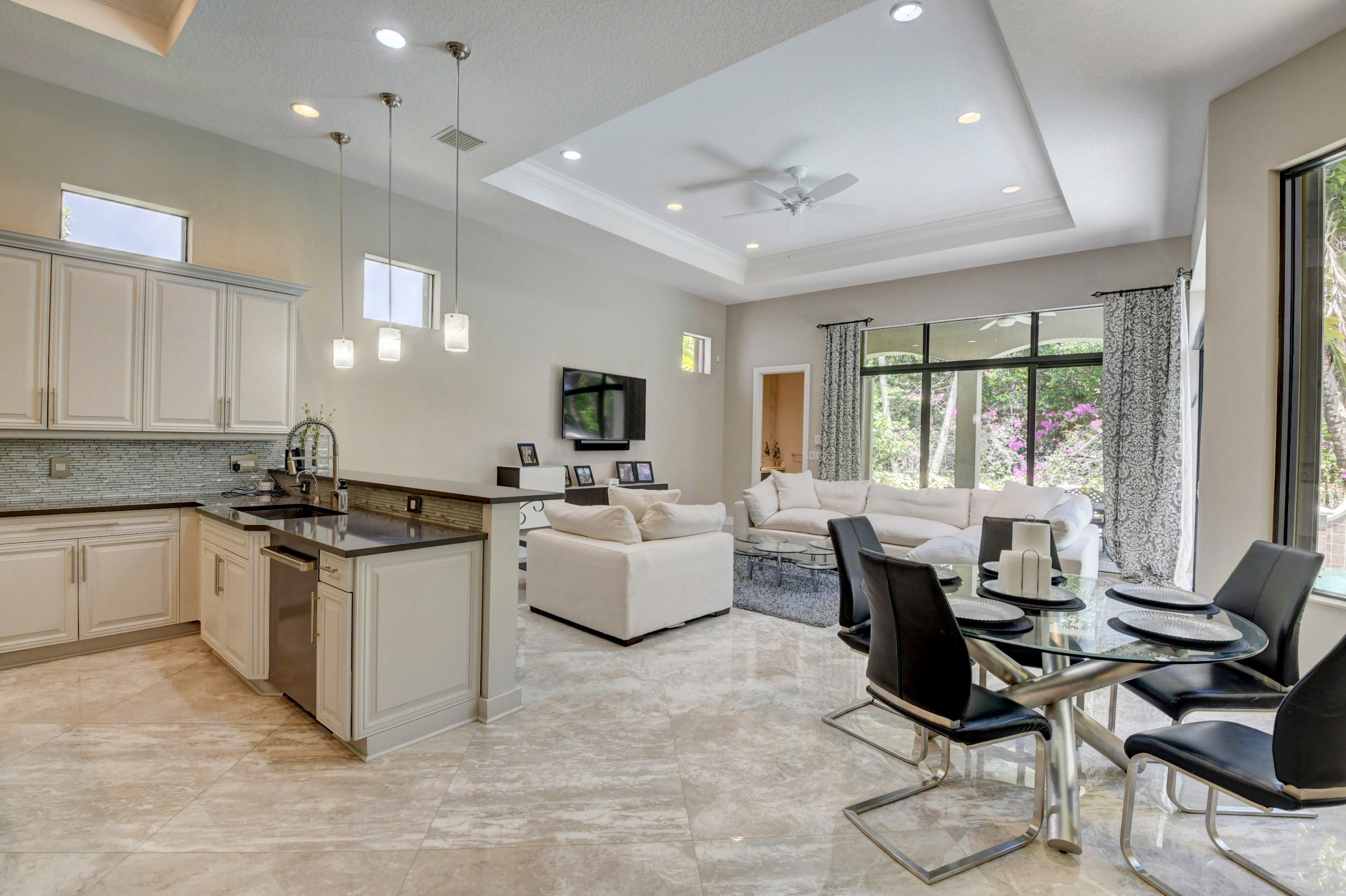17798 Cadena Drive Boca Raton, FL 33496 - Photo 10 of 49 a large white kitchen with a large window and white cabinets
