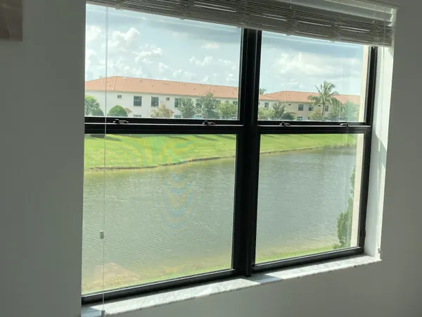 an empty room with a ceiling fan and carpet