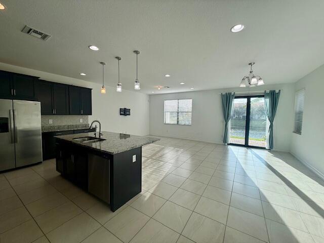 10092 Brickhill Drive Boca Raton, FL 33428 - Photo 42 of 42 a kitchen with stainless steel appliances granite countertop a stove and a refrigerator