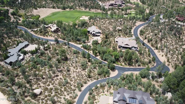an aerial view of a house with a yard and outdoor seating