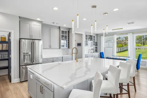 a kitchen with a sink stove and refrigerator