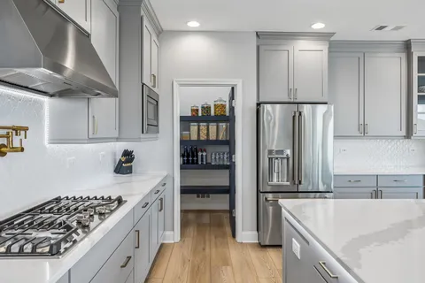 a large kitchen with a table and chairs