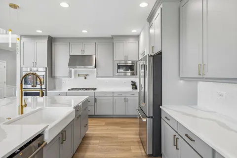 a large kitchen with cabinets table and chairs