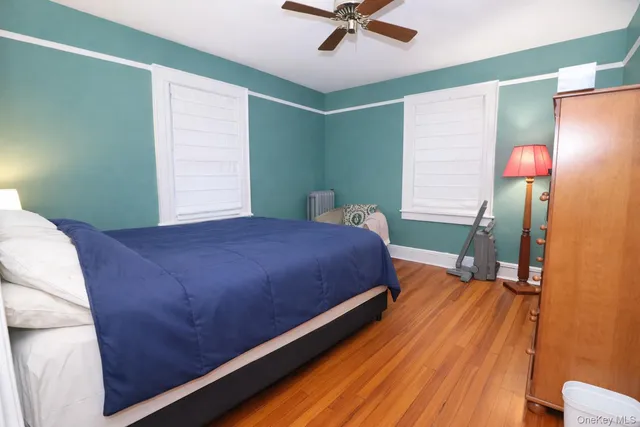 a bedroom with a bed and a mirror