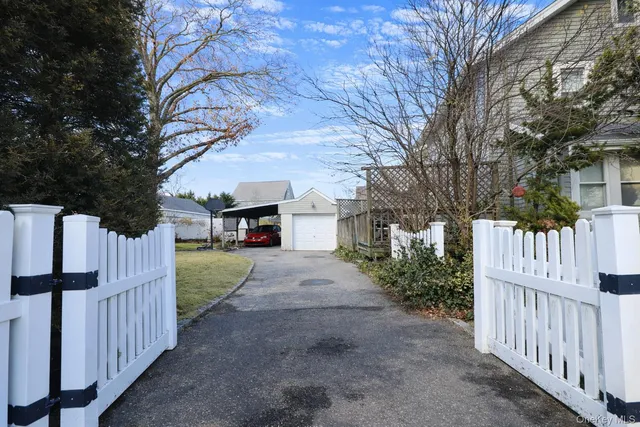 a street view of a house with a yard covered with snow