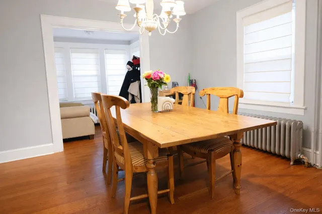 a view of a dining room with furniture and a chandelier