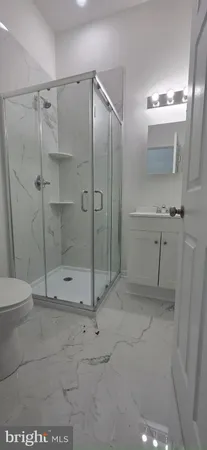 a bathroom with a shower and a toilet