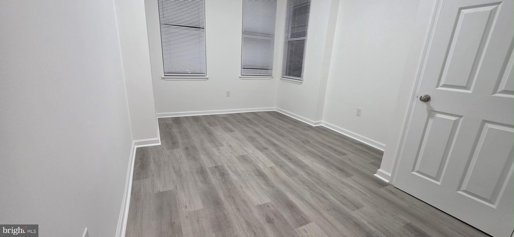 2233 North 16th Street Philadelphia, PA 19132 - Photo 17 of 21 a view of an empty room with wooden floor and entrance