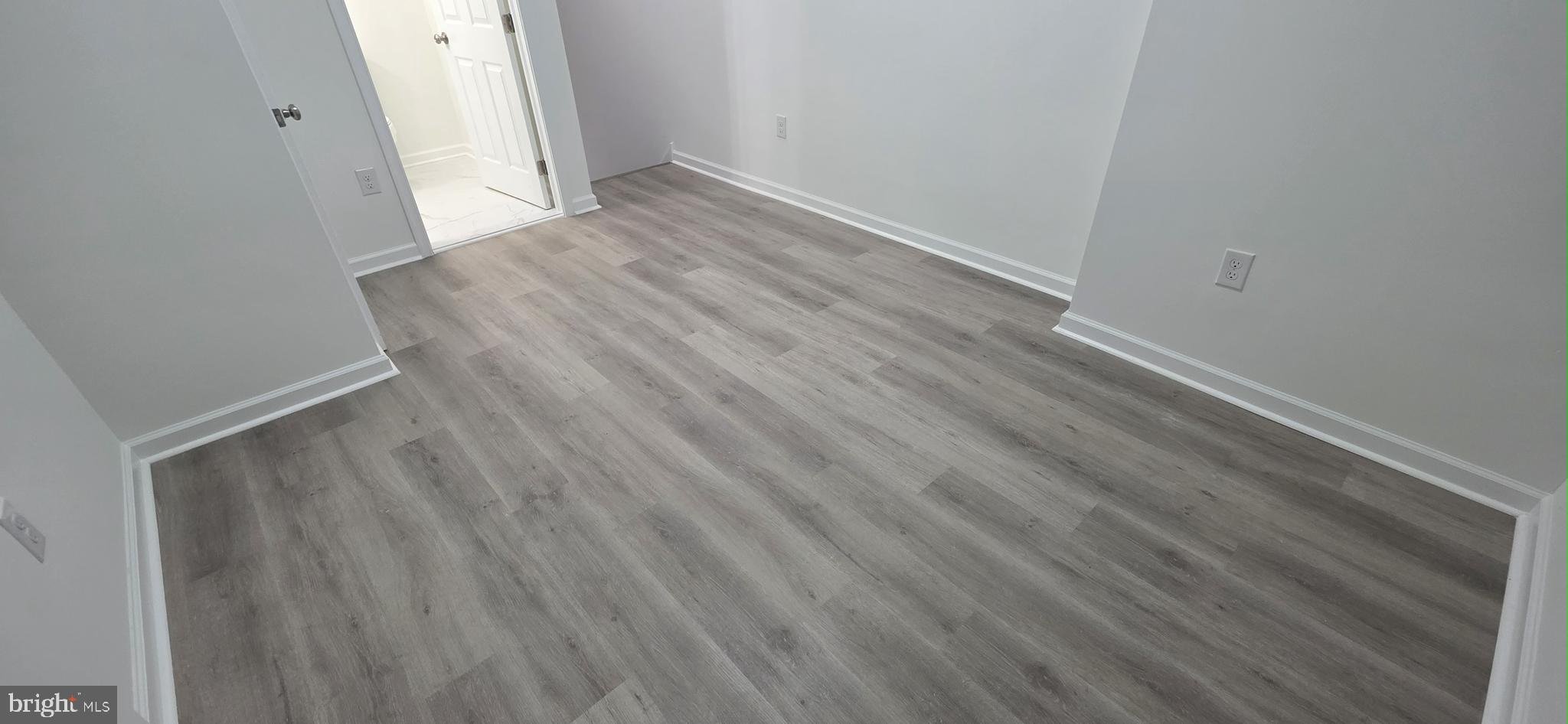 2233 North 16th Street Philadelphia, PA 19132 - Photo 18 of 21 a view of an empty room with wooden floor