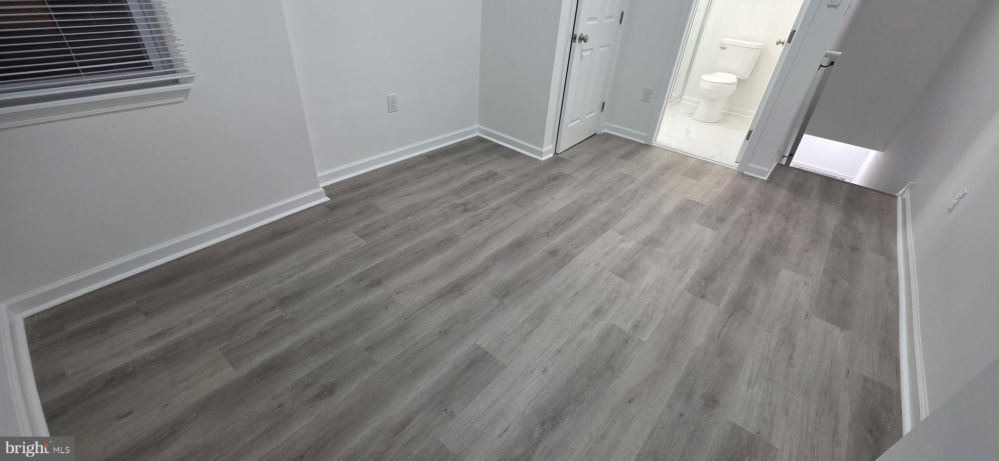 2233 North 16th Street Philadelphia, PA 19132 - Photo 19 of 21 a view of an empty room with wooden floor