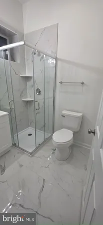 a bathroom with a toilet and a shower