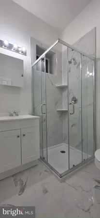 a bathroom with a shower a sink and a mirror