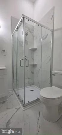 a bathroom with a shower and a toilet