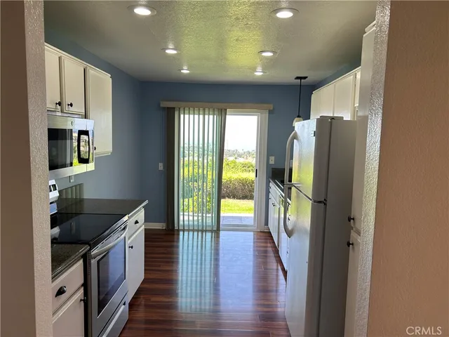 a kitchen with granite countertop a stove and a microwave