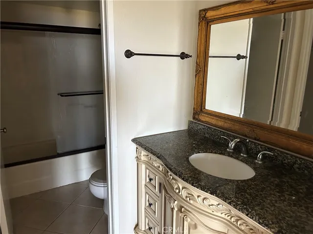 a hallway with wooden floor fireplace and a window