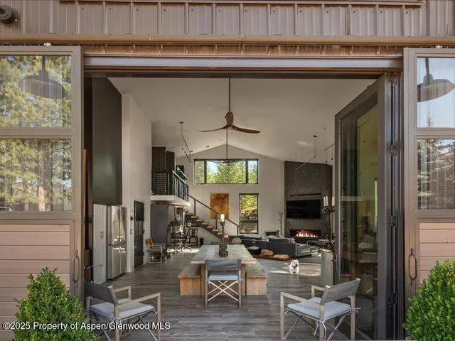 a living room with furniture a chandelier and a flat screen tv