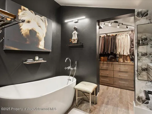 a bathroom with a tub and a mirror