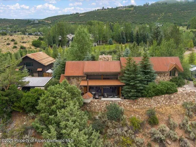 an aerial view of a house with pool lake view and mountain view
