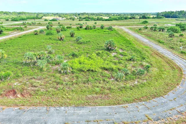 a view of a green field with an ocean view