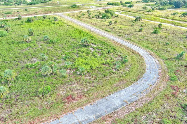 a view of a water pond with green field