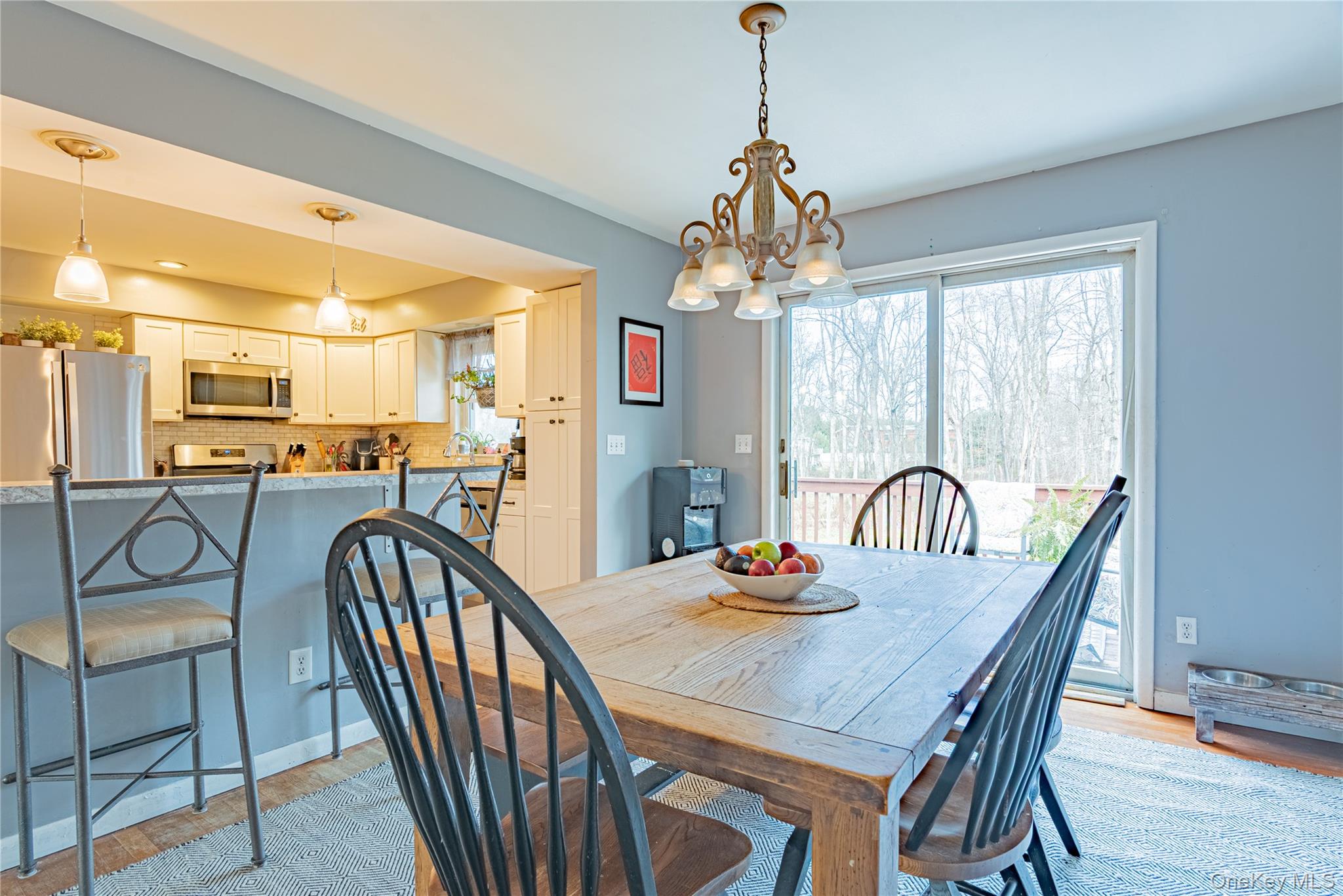 105 Oak Ridge Road Hopewell Junction, NY 12533 - Photo 14 of 32 a view of a dining room and livingroom with furniture wooden floor a chandelier