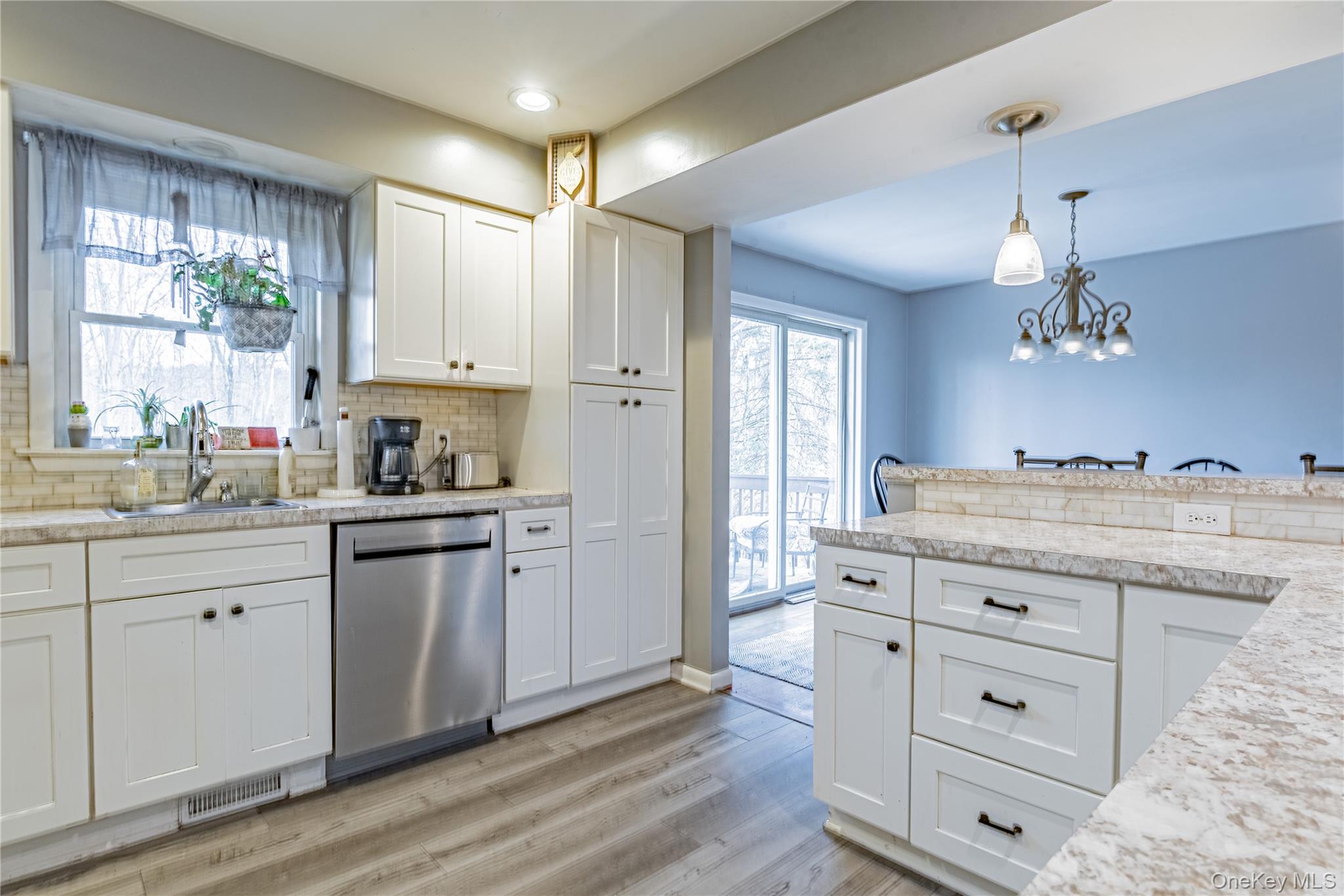 105 Oak Ridge Road Hopewell Junction, NY 12533 - Photo 7 of 32 a kitchen with cabinets wooden floor and a window
