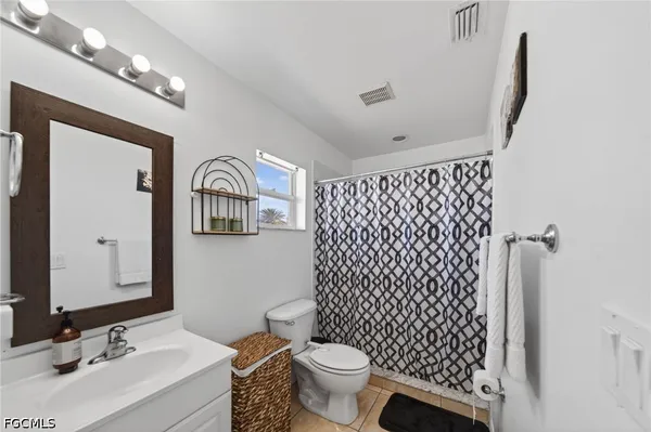 a bathroom with a sink vanity mirror and toilet