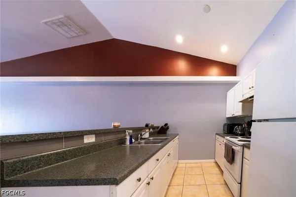 a view of kitchen with granite countertop lots of counter top space