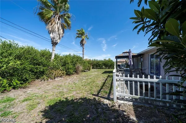 a view of a house with a small yard and deck