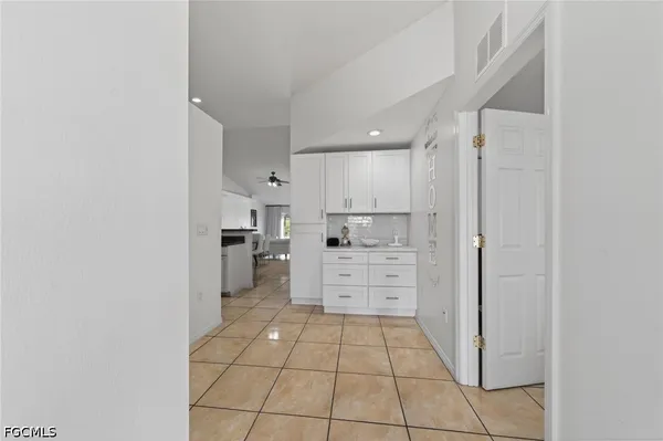 a kitchen with white cabinets and white appliances