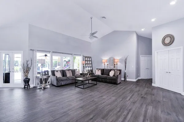 a view of a patio with a table and chairs under an umbrella