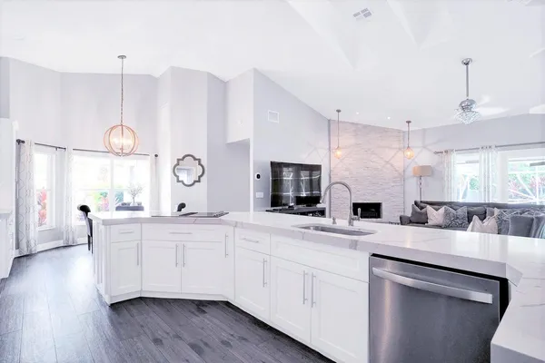 a kitchen with granite countertop a stove and a refrigerator