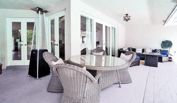 a view of a swimming pool with a yard and potted plants