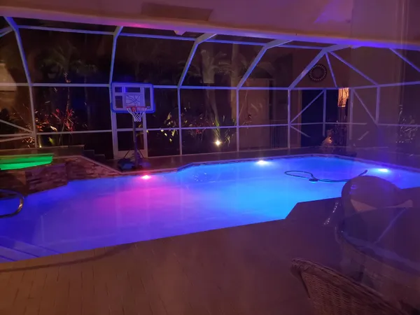 a view of a swimming pool with a porch and furniture