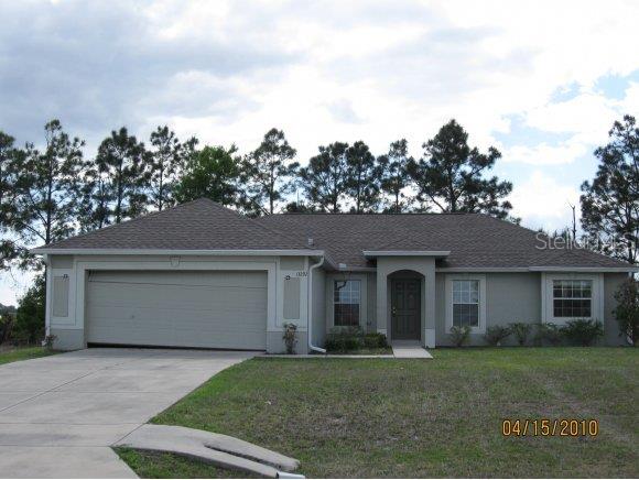 13292 Southwest 49th Avenue Ocala, FL 34473 - Photo 1 of 1 front view of a house with a yard