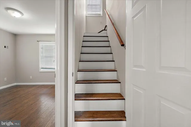 a view of entryway with wooden floor and stairs