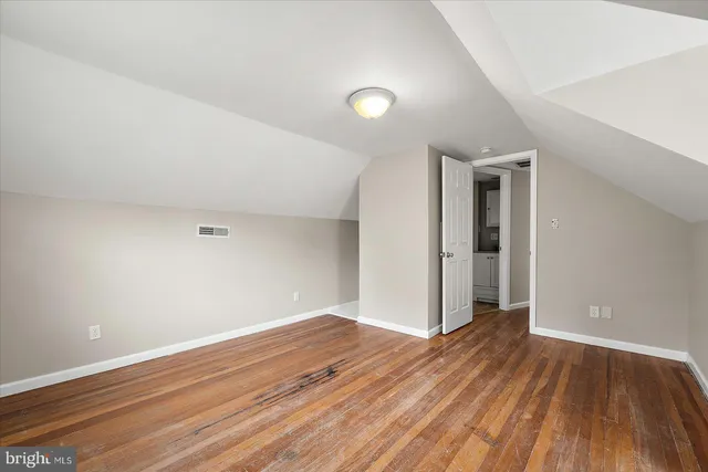 a bathroom with a granite countertop toilet sink and mirror