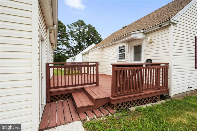 a backyard of a house with wooden floor and fence