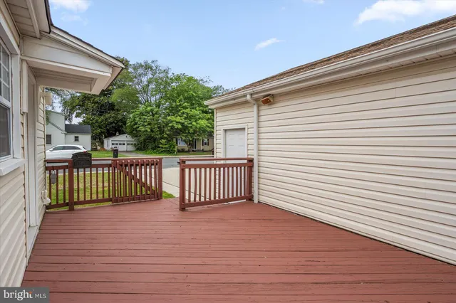 a view of a wooden deck with a yard