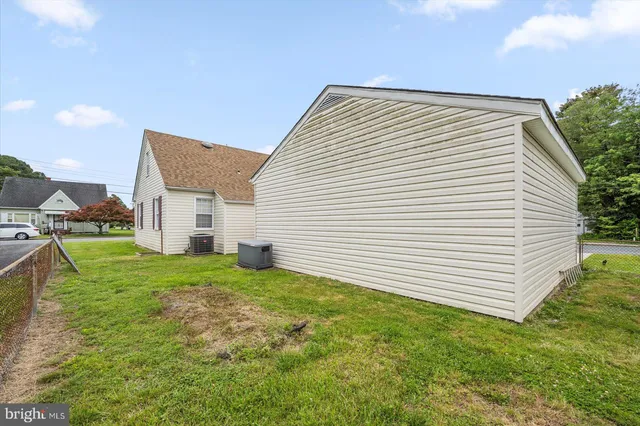 a view of a small house and a yard