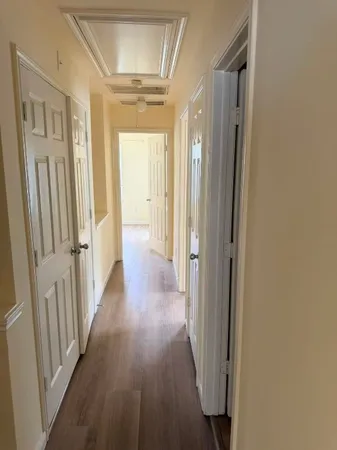 an empty room with wooden floor and closet