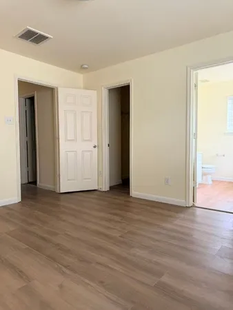 a bathroom with a tub a sink and a large mirror