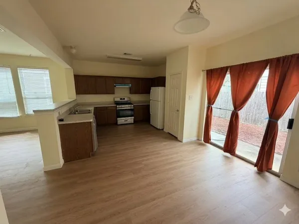 a view of a backyard with wooden fence