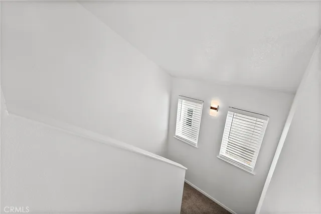 a view of a livingroom with wooden floor and windows