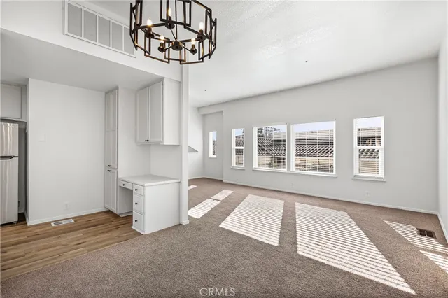 a view of a room with a window and chandelier