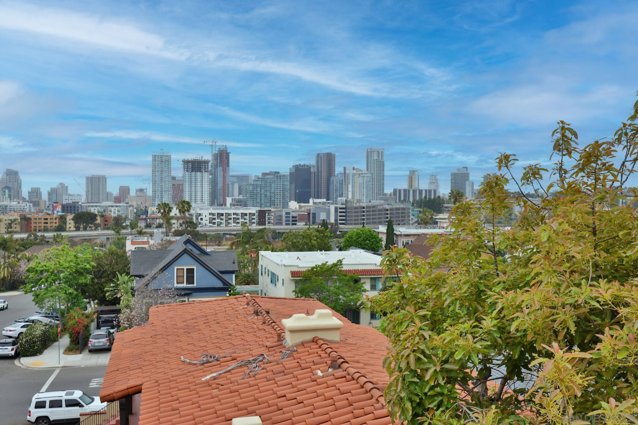 2220 E Street San Diego, CA 92102 - Photo 12 of 13 a front view of a house with a yard and trees